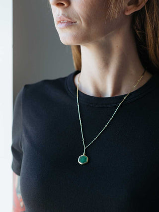 gold cast line necklace with emerald pendant